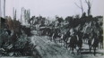 1 Mounted Allied troops pass through a devasatated town in France.